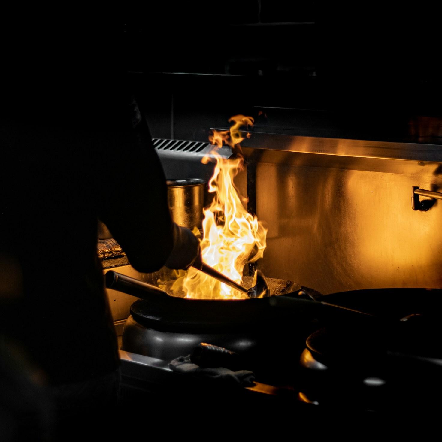 Diverse group of community members sharing a meal together, showcasing the social bonds formed through collaborative cooking